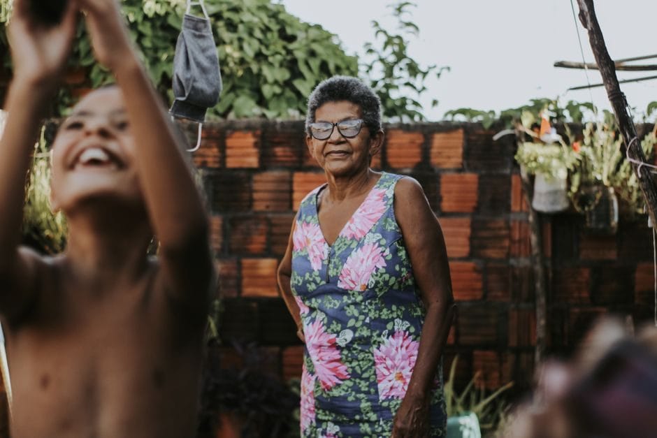 A grandmother and grandchild together in a sunny garden